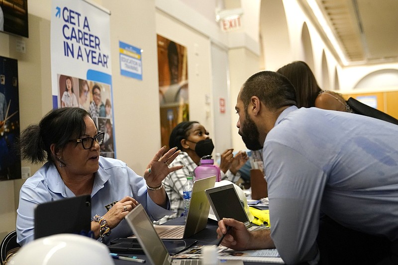 A job seeker talks with Victoria Tomas, Construction Trades Program Manager with Florida International University at the 305 Second Chance Job & Resource Expo., on June 10 in Miami. The event was sponsored by the Florida Rights Restoration Coalition.
(AP)