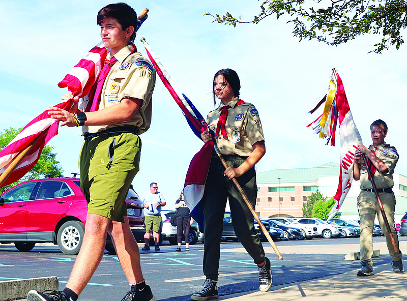 Hundreds of Scouts gather at the 21st Merit Badge University on Saturday, July 23, 2022, at State Technical College of Missouri in Linn. From left, Carson Kliethermes, Naomi Snyder, and Jason Greer present the colors. (Kate Cassady/News Tribune)