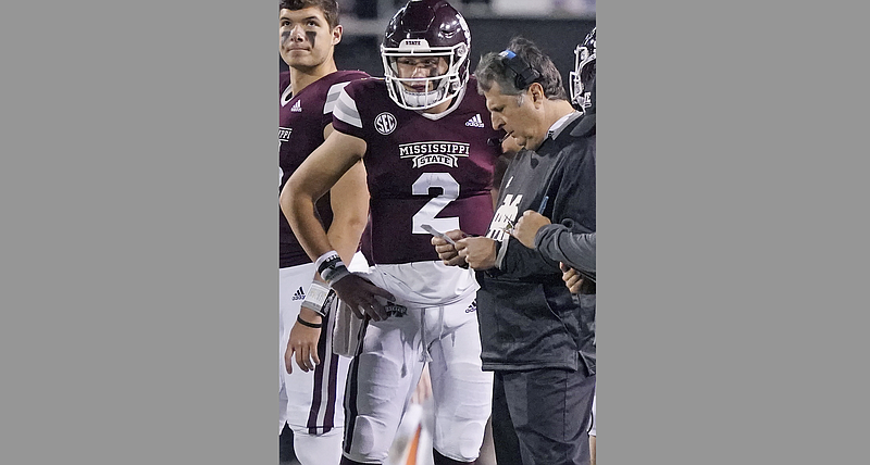 Mississippi State quarterback Will Rogers (2) confers with head coach Mike Leach during a timeout in the second half of an NCAA college football game against Kentucky in Starkville, Miss., Saturday, Oct. 29, 2021. Mississippi State won 31-17. (AP Photo/Rogelio V. Solis)