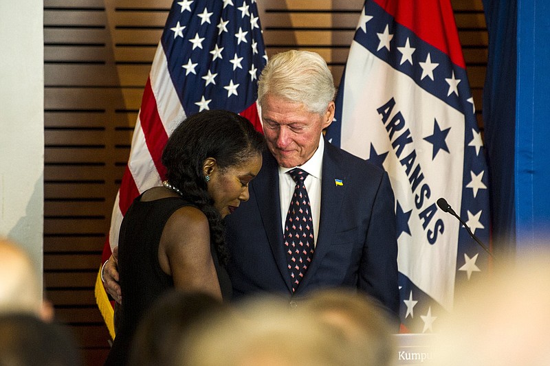 Pulitzer Prize-winning author Isabel Wilkerson hugs former President Bill Clinton as she makes her way onstage Wednesday during a Kumpuris Distinguished Lecture at the Clinton Presidential Center. More photos at arkansasonline.com/727clinton/.
(Arkansas Democrat-Gazette/Stephen Swofford)