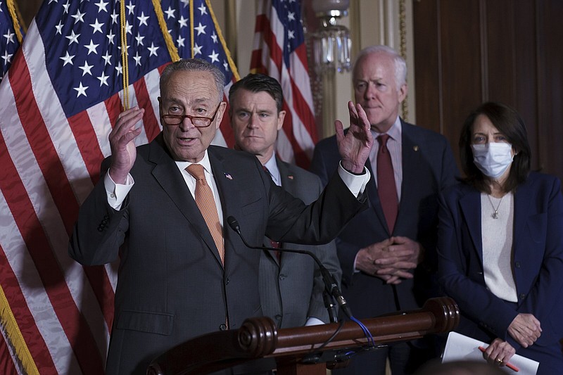 Senate Majority Leader Chuck Schumer, D-N.Y., (from left) Sen. Todd Young, R-Ind., and Sen. John Cornyn, R-Texas, talk Wednesday about the bipartisan effort to pass a bill designed to encourage more semiconductor companies to build chip plants in the United States, at the Capitol in Washington.
(AP/J. Scott Applewhite)