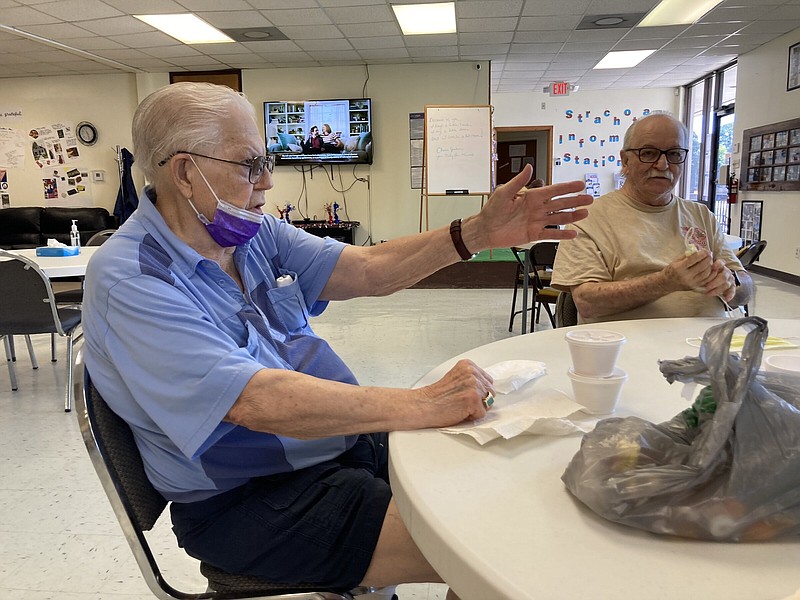 Bennie Warren (left) talks about the hot weather and the importance of being near air conditioning at this time of the year. Sitting next to him is Gary Lipsitz. 
(Pine Bluff Commercial/Byron Tate)