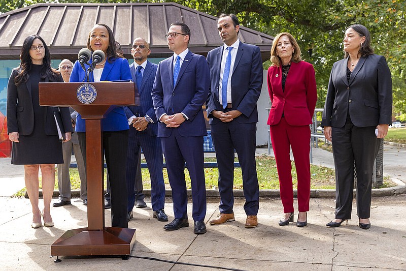 Kristen Clarke, at podium, Assistant Attorney General for the Justice Department's Civil Rights Division, is joined with, from left, New Jersey First Assistant Attorney General Lyndsay Ruotolo, Pennsylvania state Sen. Vincent Hughes, Pennsylvania Attorney General Josh Shapiro, Rohit Chopra, CFPB Director, Delaware Attorney General Kathy Jennings and Jacqueline C. Romero, United States Attorney for the Eastern District of Pennsylvania during a press conference at Malcolm X Park, Wednesday morning. July 27, 2022, West Philadelphia, Pa. (Alejandro A. Alvarez/The Philadelphia Inquirer via AP)