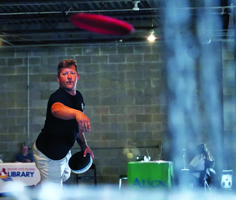 Eric Henley throws a disc Tuesday, July 26, 2022, during the disc golf tournament at the Jefferson City Jaycees Cole County Fairgrounds.  (Kate Cassady/News Tribune photo)