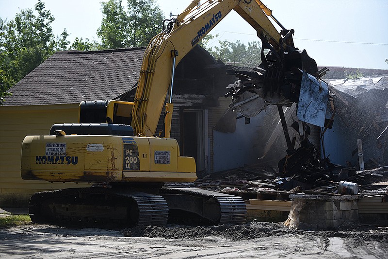 An excavator tears down a dilapidated structure Wednesday to make way for The Station, a shelter for young people ages 18-24, at 3201 Mary St. in Little Rock.
(Arkansas Democrat-Gazette/Staci Vandagriff)