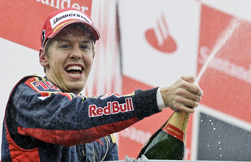 Sebastian Vettel celebrates on podium after taking his Toro Rosso to victory during the 2008 Italian Grand Prix in Monza, Italy. The four-time Formula One champion said he will retire at the end of the season to spend more time with his family. The German driver won F1 titles in 2010-13 with the Red Bull team and his last race victory came with Ferrari in 2019.
(AP/Alberto Pellaschiar)