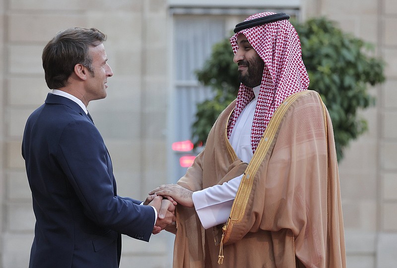French President Emmanuel Macron (left) welcomes Saudi Crown Prince Mohammed bin Salman for a dinner Thursday at the Elysee Palace in Paris.
(AP/Lewis Joly)