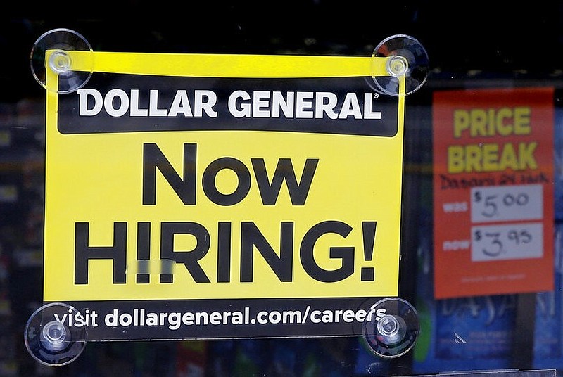 A "Now Hiring" sign hangs in the window of a Dollar General store in this May 18, 2016 file photo. (AP/Charles Krupa)