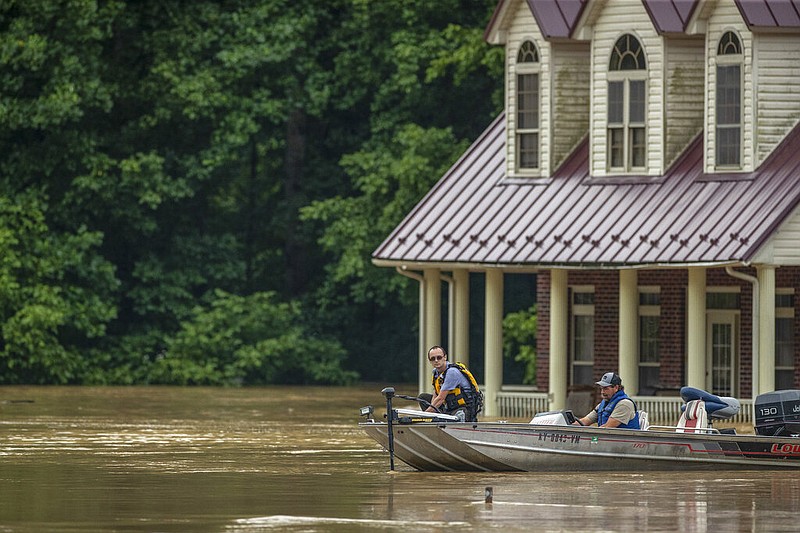 Homes are flooded by Lost Creek, Ky., on Thursday, July 28, 2022.  Heavy rains have caused flash flooding and mudslides as storms pound parts of central Appalachia. Kentucky Gov. Andy Beshear says it's some of the worst flooding in state history.  (Ryan C. Hermens/Lexington Herald-Leader via AP)