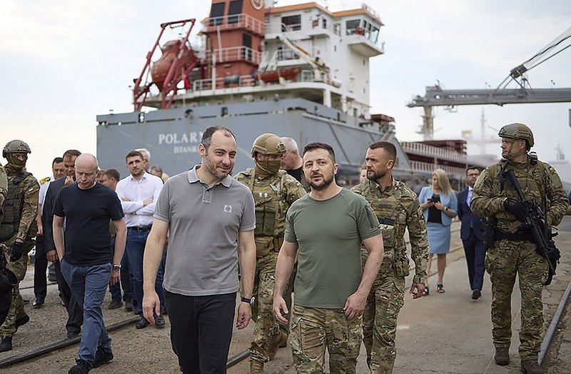Ukrainian President Volodymyr Zelenskyy (center), surrounded by ambassadors of different countries and officials of the United Nations, visits the Black Sea port of Chornomorsk on Friday as grain is loaded onto a Turkish ship. Grain exports are resuming under an agreement brokered by Turkey and U.N. officials. More photos at arkansasonline.com/ukrainemonth6/.
(AP/Ukrainian Presidential Press Office)