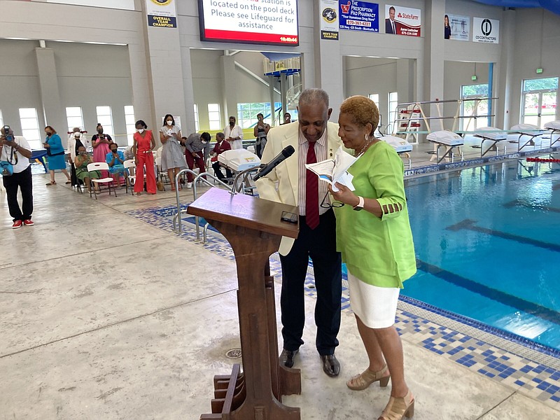 Mayor Shirley Washington turns the podium over to former mayor Carl Redus Jr. during a ceremony on Friday to honor Redus and the renaming of the city’s aquatics center to the Carl A. Redus Jr. Aquatics Center. 
(Pine Bluff Commercial/Byron Tate)