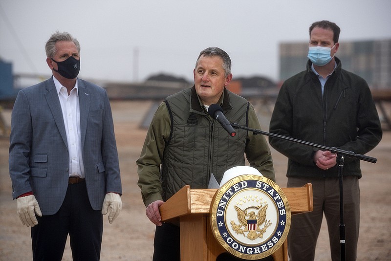 House Minority Leader Kevin McCarty of Calif., left, and Rep. August Pfluger, R-Texas, right, listen as Rep. Bruce Westerman, R-Ark., talks to the media following a tour of a Diamondback Energy oil rig Feb. 10, 2021 in Midland, Texas. 
(Eli Hartman/Odessa American via AP, File)