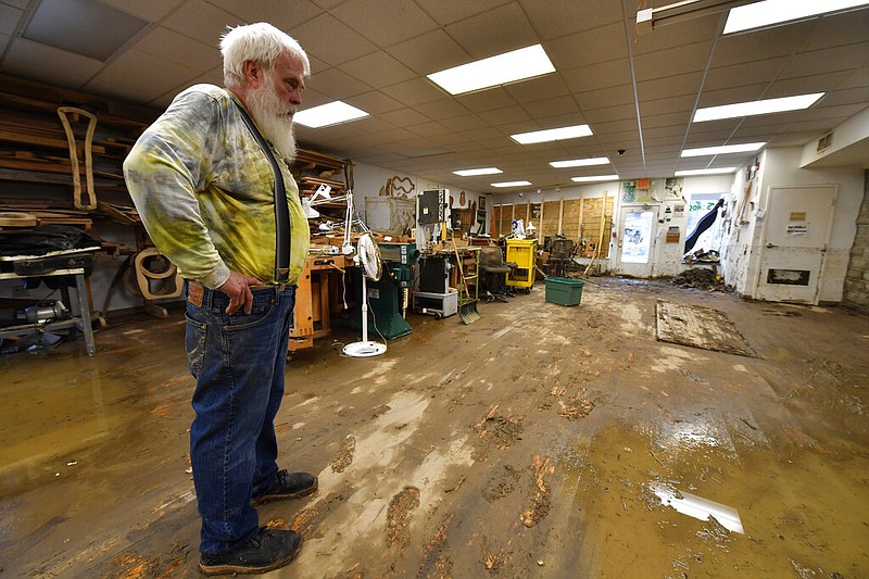 Paul Williams, luthery instructor at the Applachian School of Luthery inspects the damage at the workshop and museum in Hindman, Ky., Sunday, July 31, 2022. (AP/Timothy D. Easley)