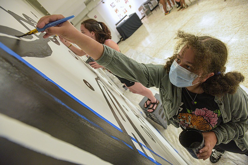 Likensa Schembra, 13, helps paint a mural on Thursday, July 28, 2022, at the Fort Smith Regional Art Museum’s four-day youth camp Become a Muralist in Fort Smith. Visit nwaonline.com/220731Daily/ for today's photo gallery..(NWA Democrat-Gazette/Hank Layton)