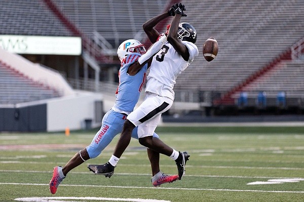 Little Rock Parkview’s Tayvion Haney (left) breaks up a pass intended for White Hall wide receiver Jordan Jackson on Friday at War Memorial Stadium.