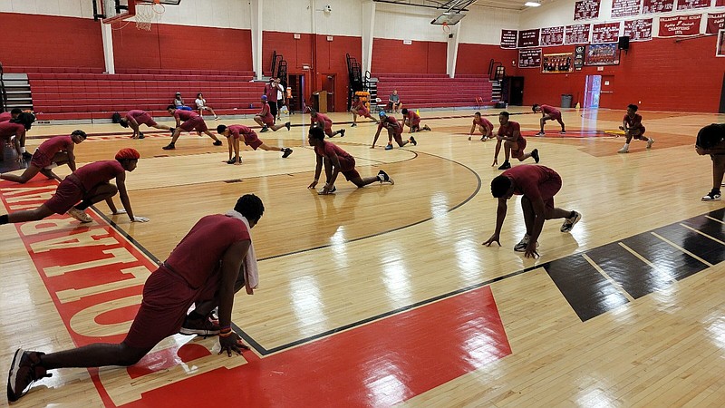 Dollarway High School football players warm up on the redesigned basketball floor at the Dollarway Fieldhouse on the old high school campus Wednesday. Cardinal Stadium is located just to the rear of the fieldhouse. 
(Pine Bluff Commercial/I.C. Murrell)