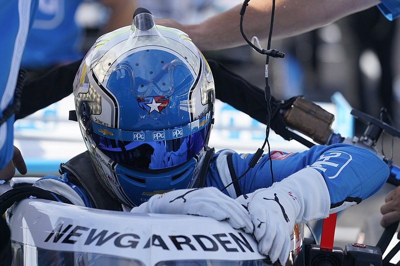 Josef Newgarden climbs into his car during a practice session at Indianapolis Motor Speedway last week. Newgarden, who was airlifted to a nearby hospital after collapsing in the motorhome lot at Iowa Motor Speedway on July 24, is hoping to get back to 100% so he can maintain his third-place ranking in the IndyCar standings.
(AP/Darron Cummings)