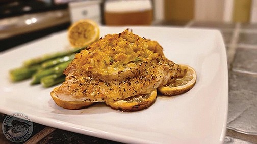 Crab-stuffed striped bass offers a lighter take on fish than a simple fish fry. Grilling on a bed of lemon slices prevents the fish from burning and adds a smoky citrus flavor. 
(Special to The Commercial/Arkansas Game and Fish Commission)