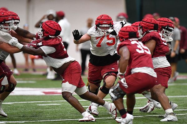 Arkansas offensive lineman Patrick Kutas (75) blocks Friday, Aug. 5, 2022, during practice at in Fayetteville. Visit nwaonline.com/220806Daily/ for today's photo gallery. ...(NWA Democrat-Gazette/Andy Shupe)