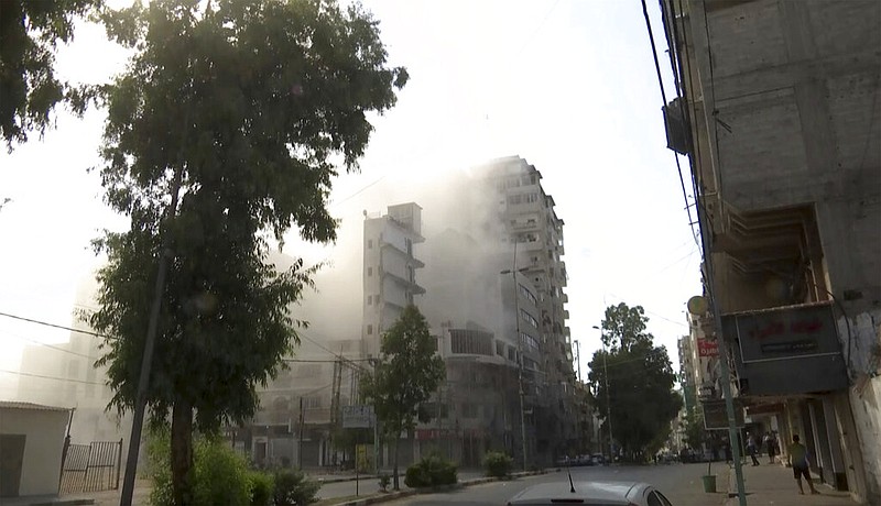 Smoke pours out of a tall building after an Israeli airstrikes in Gaza City, on Friday, Aug. 5, 2022. Israel unleashed a wave of airstrikes in Gaza on Friday, killing several people. (AP Photo)