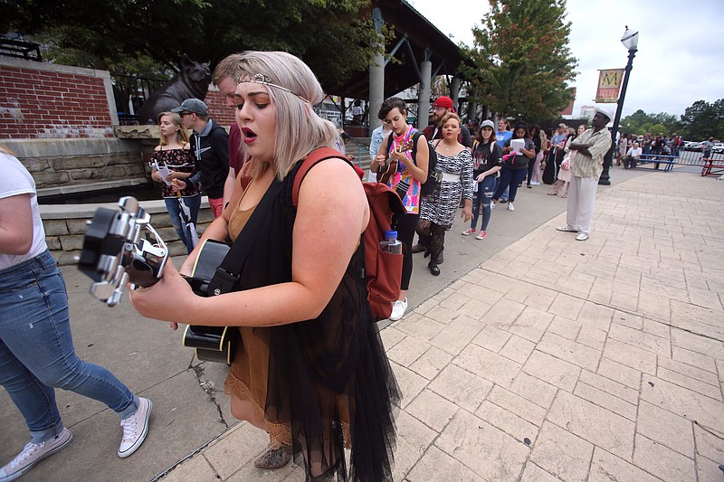 Sam Hill sings and plays her guitar while waiting in line for the live "American Idol" Sept. 12, 2018, at Little Rock's River Market.
(Democrat-Gazette file photo/Thomas Metthe)