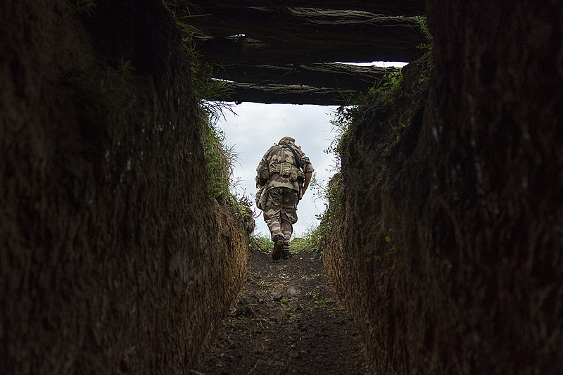 Sgt. Maj. Artur Shevtsov of the Dnipro-1 regiment leaves a bunker Friday at the unit’s position near Sloviansk in the Donetsk region of eastern Ukraine. The unit is expanding a network of trenches and bunkers. More photos at arkansasonline.com/ukrainemonth6/.
(AP/David Goldman)