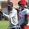 Arkansas assistant coach Jimmy Smith speaks Friday, Aug. 5, 2022, alongside running back Raheim Sanders during practice at the university practice facility in Fayetteville.