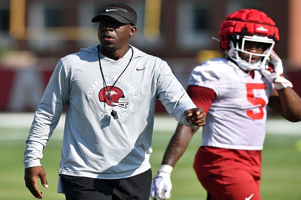 Arkansas assistant coach Jimmy Smith speaks Friday, Aug. 5, 2022, alongside running back Raheim Sanders during practice at the university practice facility in Fayetteville. Visit nwaonline.com/220806Daily/ for today's photo gallery.