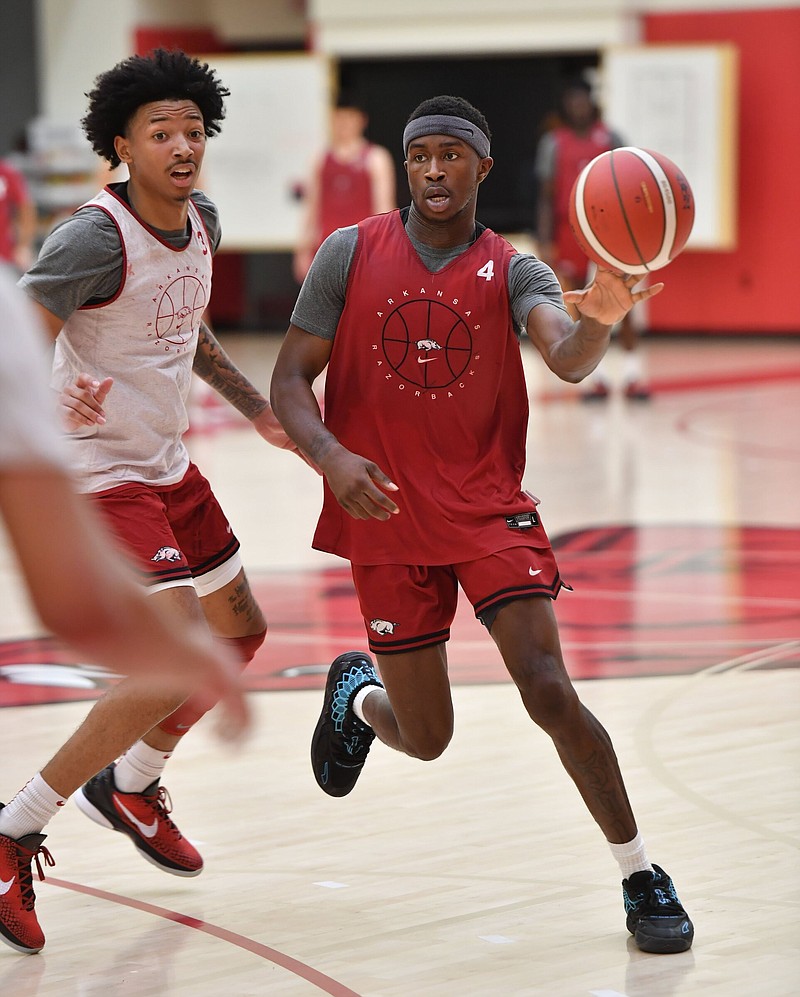 Arkansas guard Davonte Davis (4) passes the ball Wednesday, July 27, 2022, during practice in the Eddie Sutton MenÕs Basketball Practice Gym on the university campus in Fayetteville. Visit nwaonline.com/220728Daily/ for today's photo gallery. .(NWA Democrat-Gazette/Andy Shupe)