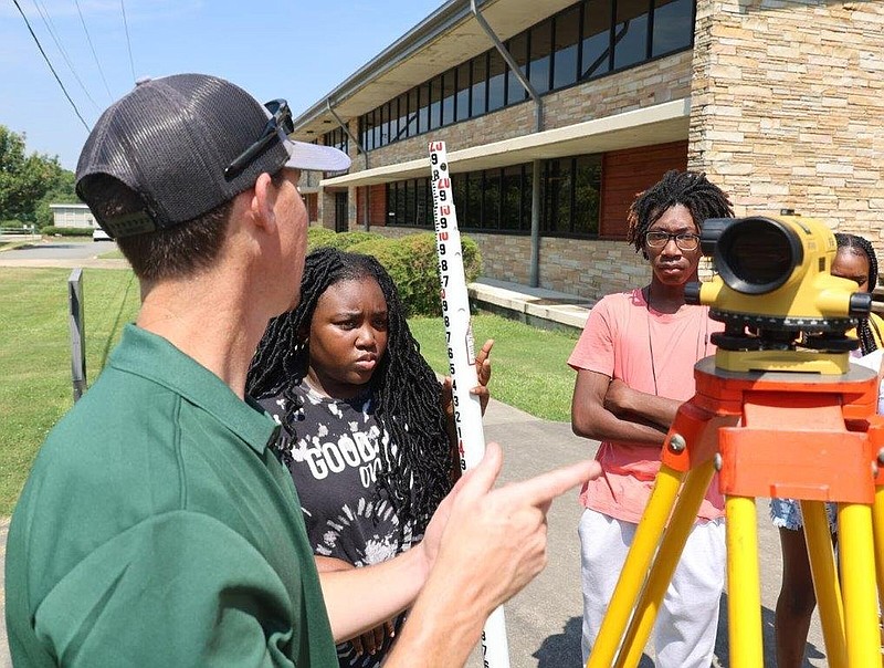 UAM Land Survey Instructor Robert Blakeley shows India Campbell, ninth grade, and Kylan Galloway, 11th grade, of Hamburg High School, how to use land survey equipment. 
(Special to The Commercial/University of Arkansas at Monticello)