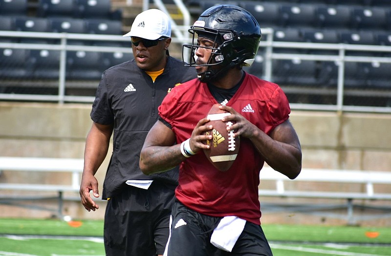 UAPB fifth-year quarterback Skyler Perry drops back for a pass with position coach Kendrick Nord looking during practice Friday. 
(Pine Bluff Commercial/I.C. Murrell)