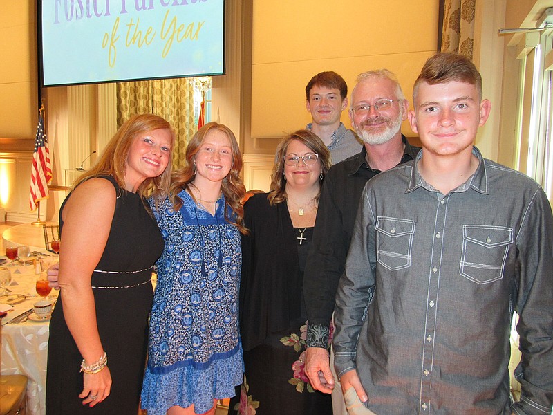 Alicia Watkins, Treasure Smithson, Theresa and Michael Smithson, Samuel Smithson and Stetson Smithson (back) on 07/22/22 at Foster Parents of the Year Banquet, Arkansas Governor’s Mansion 
(Arkansas Democrat-Gazette/Kimberly Dishongh)