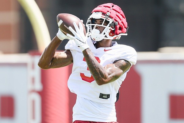 Arkansas wide receiver Matt Landers (3) completes a pass, Monday, August 8, 2022 during a football practice at University of Arkansas practice football field in Fayetteville.