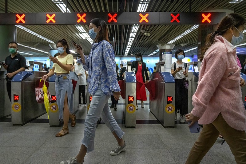 Commuters walk through a subway station during the morning rush hour in the central business district in Beijing on Tuesday. University graduates in China are struggling to land jobs this summer as covid-19 lockdowns slow the economy.
(AP/Mark Schiefelbein)