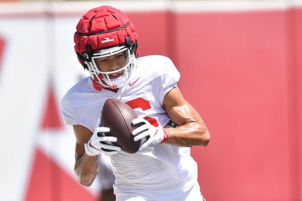 Arkansas receiver Isaiah Sategna catches a pass during practice Thursday, Aug. 11, 2022, in Fayetteville.