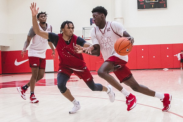 Arkansas guard Barry Dunning (12) is defended by Ricky Council (1) during a practice in Fayetteville.