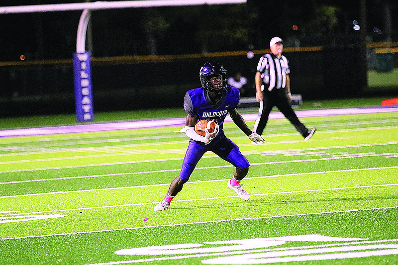 El Dorado's DeAndra Burns, Jr., fields a punt during action last season at Memorial Stadium. Burns expects to be a threat in the Wildcats' offense regardless of how many passes are thrown.