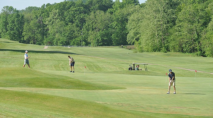 May 2016 News Tribune file photo: Golfers practice on the putting greens while waiting to play at Railwood Golf Course.