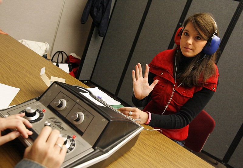 Rachel Hope, then a freshman at the University of Arkansas, Fayetteville, has her hearing checked by speech pathology graduate students during a health fair at the Arkansas Union on the Fayetteville campus in this Oct. 12, 2006 file photo. (Arkansas Democrat-Gazette file photo)