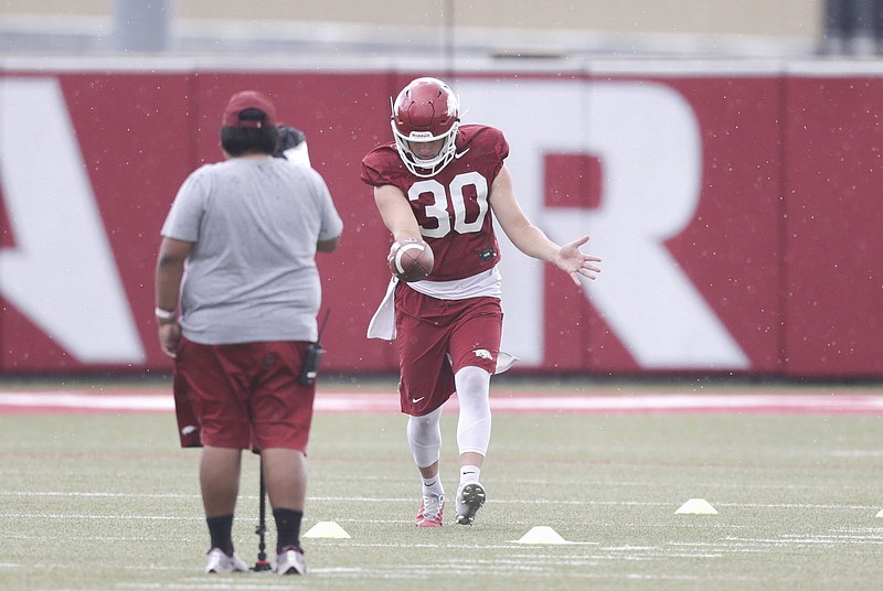 University of Arkansas punter Reid Bauer, shown working on a punting drill during fall camp last year, had his struggles as a holder for field-goal and extra-point attempts, but he worked hard to master the position going into last season.
(NWA Democrat-Gazette/Charlie Kaijo)