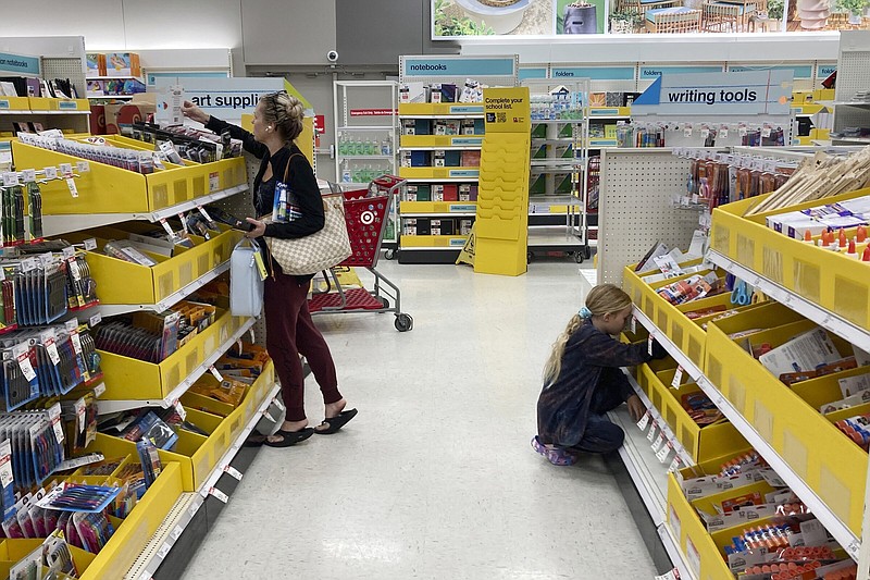 A parent shops for school supplies deals at a Target store, Wednesday, July 27, 2022, in North Miami, Fla. This back-to-school shopping season, parents, particularly in the low to middle income bracket, are focusing on the basics like no frills rainboots, while also trading down to cheaper stores, including second-hand clothing, as inflation takes a toll on their household budgets.
(AP/Marta Lavandier)