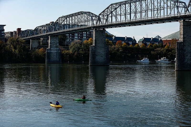 Staff photo by Troy Stolt / Daniel McCord and Josh Rogers, 14, paddle up the Tennessee River from Coolidge Park on Tuesday, Nov. 2, 2021 in Chattanooga, Tenn.