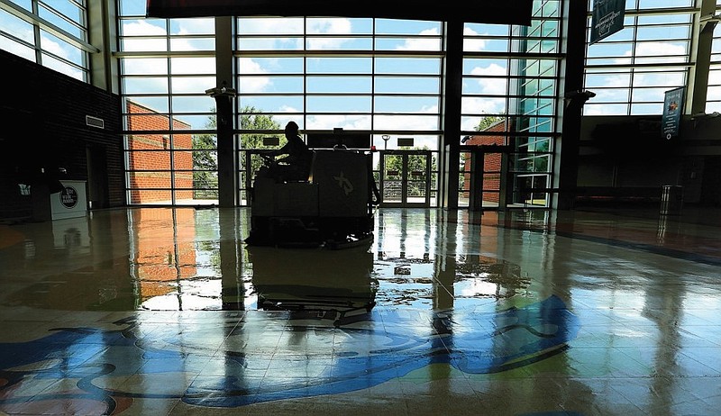 Maintenance worker Heather Shourd cleans floors at Simmons Bank Arena in North Little Rock in this June 3, 2021 file photo. (Arkansas Democrat-Gazette/Thomas Metthe)