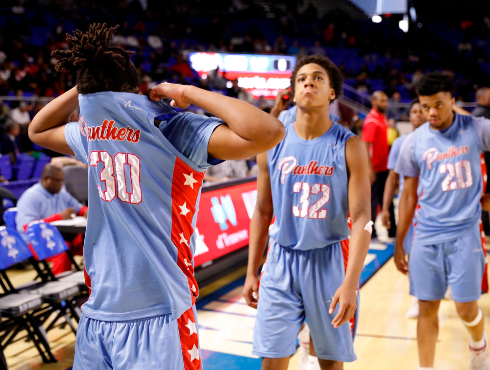 Staff photo by Doug Strickland / .Brainerd's Jamaal Ward (30, Cameron Evans (32) and Jonte Williams (20) leave the court following the Panthers' TSSAA Class AA state basketball tournament semifinal loss to the Wooddale Cardinals at Murphy Center on the campus of Middle Tennessee State University on Friday, March 15, 2019, in Murfreesboro, Tenn.