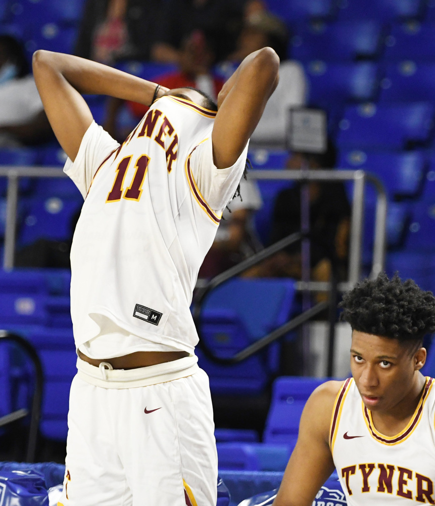 Staff Photo by Robin Rudd / Tyner's Latavious Conyers (11) covers his face as the buzzer sounds. The Tyner Rams lost to the Milan Bulldogs, 59 to 41 in the TSSAA Class 2A semifinals of the BlueCross State Championships at Middle Tennessee State University's Murphy Center on March 17, 2022.