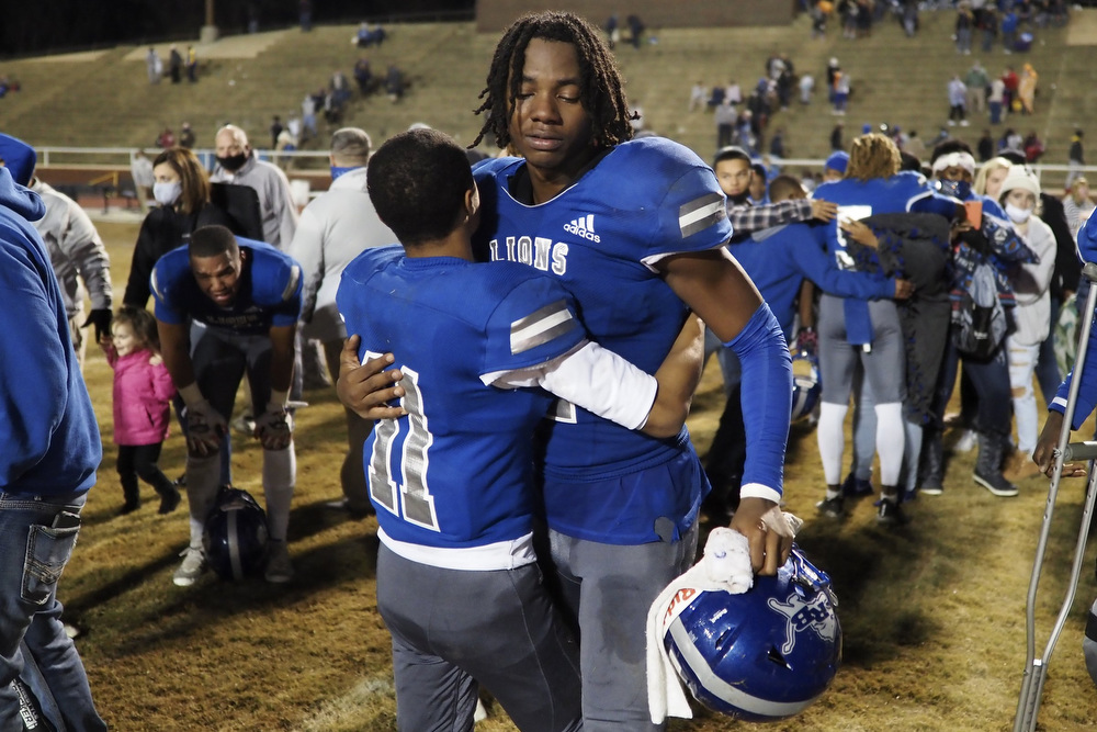 Staff photo by C.B. Schmelter / Red Bank's Josh Blackmon (11) hugs teammate Kel Eddins (2) following their loss to Alcoa during the Class 3A semifinals at Red Bank Community Stadiumon Friday, Nov. 27, 2020 in Chattanooga, Tenn.