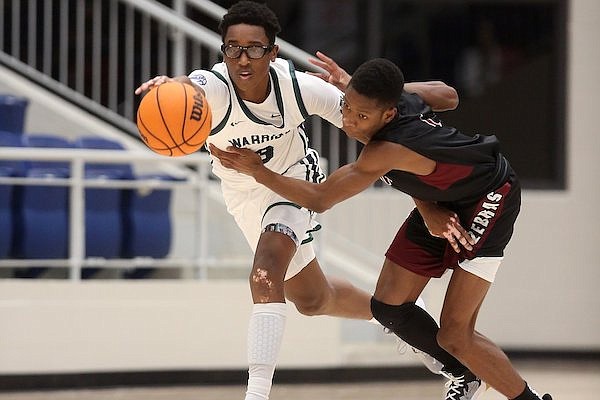 Little Rock Christian's Landren Blocker (3) steals the ball away from Pine Bluff's Cedric Adams (1) during the second quarter of the Warriors' 45-40 win on Tuesday, Nov. 16, 2021, at Warrior Arena in Little Rock.