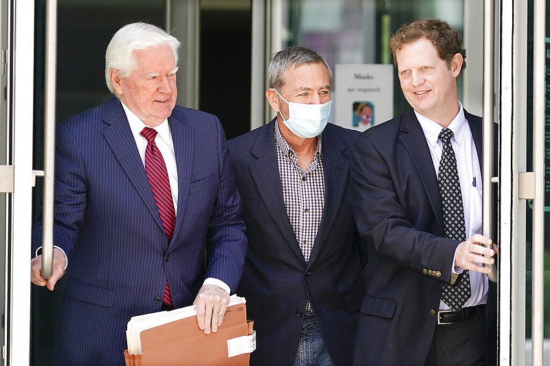 Former Tennessee House Speaker Glen Casada, center, leaves the Federal Courthouse Tuesday, Aug. 23, 2022, in Nashville, Tenn. Casada and his top aide have been arrested on federal charges including bribery, kickbacks and conspiracy to commit money laundering with federal funds. With Casada are attorneys Ed Yarbrough, left, and Jonathan Farmer, right. (AP Photo/Mark Humphrey)