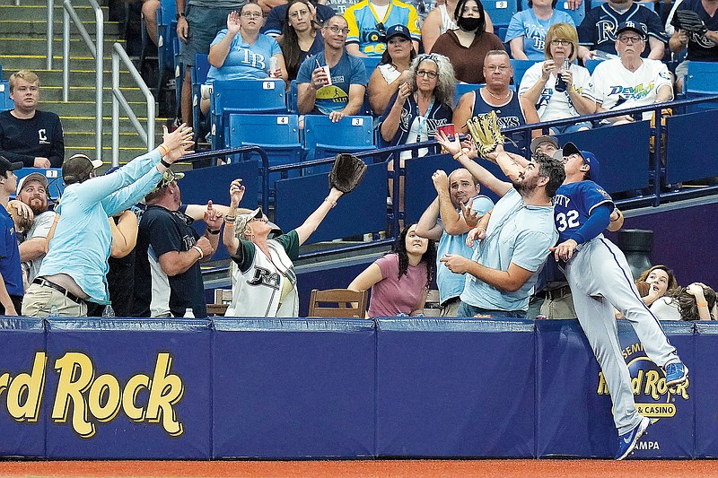 Royals left fielder Nick Pratto goes into the crowd chasing a foul ball hit by Isaac Paredes of the Rays during the third inning of Saturday’s game in St. Petersburg, Fla. (Associated Press)