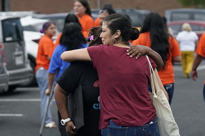 Family, parents and friends embrace Wednesday in Uvalde, Texas, after Uvalde School District Police Chief Pete Arredondo was dismissed by the Board of Trustees of the Uvalde Consolidated Independent School District.
(AP/Eric Gay)